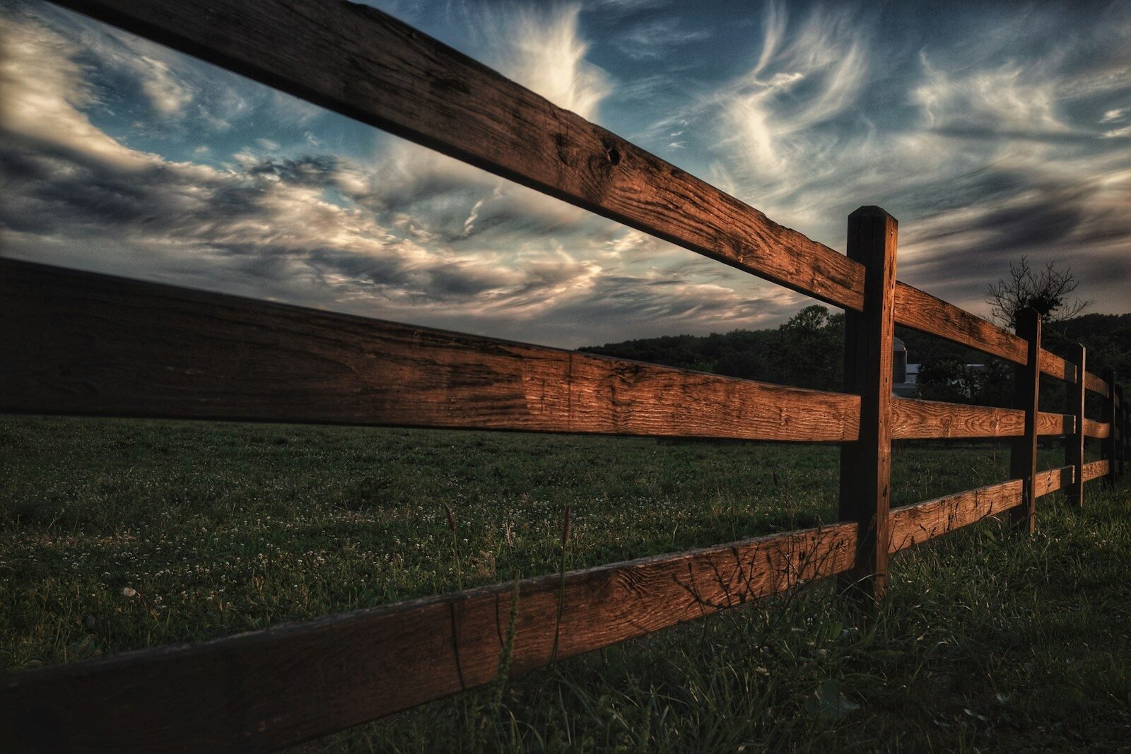 Wooden fence beside a reclaimed grass field